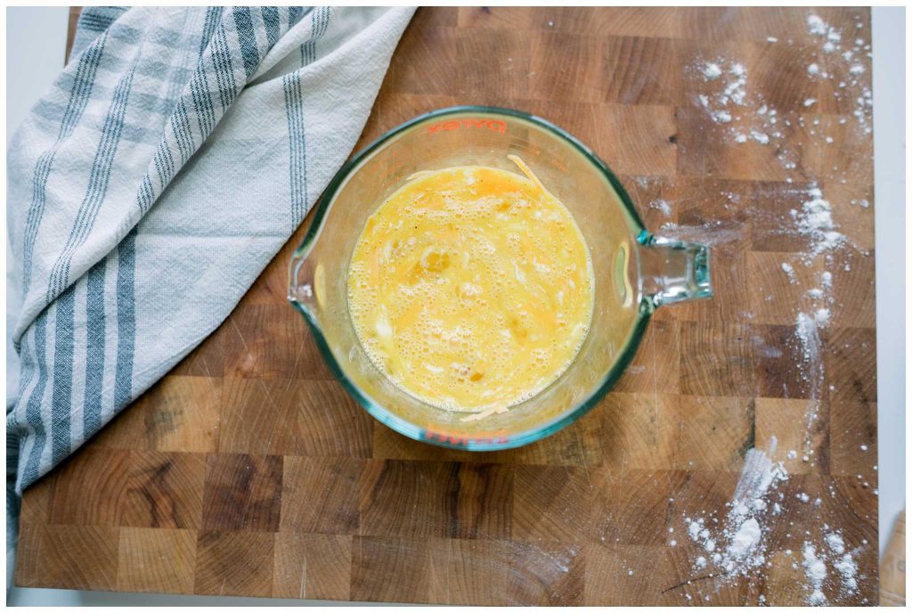 Eggs with cheese in a measuring cup for Ham and Potato Frittata