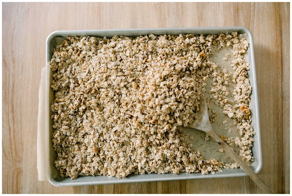 Stirring homemade granola Halfway done with baking